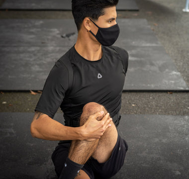 Seated Spinal Twist wearing the Dorsum Exospine Back Support to increase mobility.